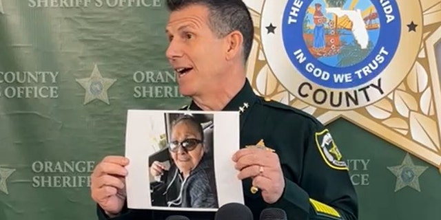 Orange County Sheriff John Mina holds up a picture of Dolores Padilla Marrero during a press conference on Thursday