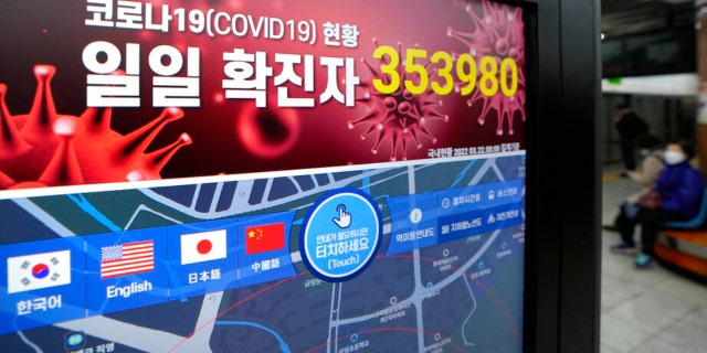 A screen shows the number of coronavirus infections nationwide at a subway station in Seoul, South Korea, Tuesday, March 22, 2022.