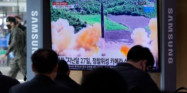 People watch a TV showing a file image of North Korea's missile launch during a news program at the Seoul Railway Station in Seoul, South Korea, Saturday, March 5, 2022. (Associated Press)