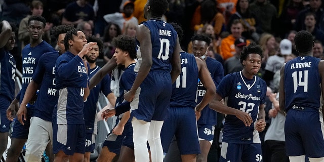 Saint Peter's players celebrate after defeating Murray State in a college basketball game in the second round of the NCAA tournament, Saturday, March 19, 2022, in Indianapolis. (AP Photo/Darron Cummings)
