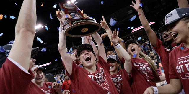 Stanford players celebrate with the regional trophy after they beat Texas 59-50 in a college basketball game in the Elite 8 round of the NCAA tournament, Sunday, March 27, 2022, in Spokane, Wash. Stanford won 59-50.