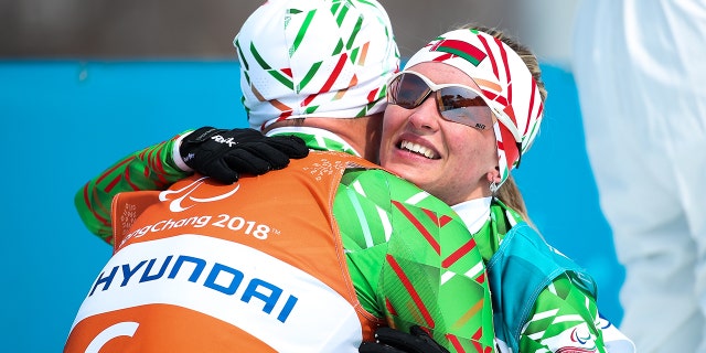 Gold medalist Sviatlana Sakhanenka (R) of Belarus celebrate with her guide Raman Yashchanka after the Women's 15km Free, Visually Impaired Cross Country event at Alpensia Biathlon Centre during day three of the Pyeongchang 2018 Paralympic Games on March 12, 2018, in Pyeongchang-gun, South Korea.