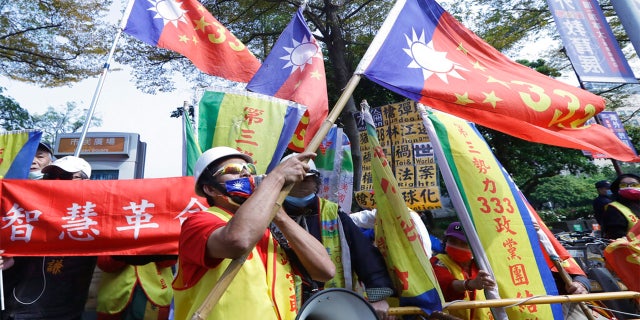 Pro-China protesters shout slogans outside of the hotel where former U.S. Secretary of State Mike Pompeo will deliver a speech in Taipei, Taiwan, Friday, March 4, 2022.