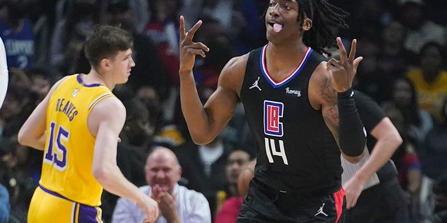 Los Angeles Clippers guard Terance Mann (14) reacts after making a 3-point basket during the first half of the team's NBA basketball game against the Los Angeles Lakers on Thursday, March 3, 2022, in Los Angeles.