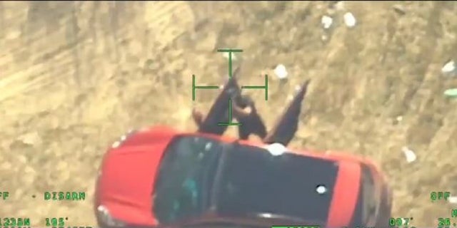 A suspect cartel member appears to point an AK-47 at a Texas Department of Public Safety helicopter patrolling on the U.S. side of the southern border. 