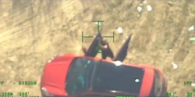 A suspect cartel member appears to point an AK-47 at a Texas Department of Public Safety helicopter patrolling on the U.S. side of the southern border. 