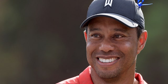 Tiger Woods smiles at the 12th hole during the final round of the PNC Championship at the Ritz Carlton Golf Club Grande Lakes Dec. 19, 2021, in Orlando, Fla.