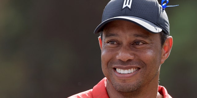 Tiger Woods smiles at the 12th hole during the final round of the PNC Championship at the Ritz Carlton Golf Club Grande Lakes Dec. 19, 2021, in Orlando, Fla.