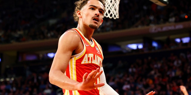 Atlanta Hawks guard Trae Young (11) motions to the crowd during the first half of an NBA basketball game against the New York Knicks, Tuesday, March 22, 2022, in New York.