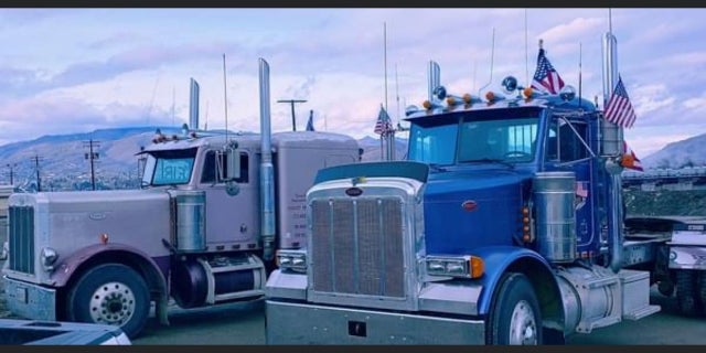 Trucks park side-by-side taking part in a nationwide convoy from California to Washington D.C. Thousands of truckers are convoying from various parts of the country to protest COVID-19 mandates and other issues.