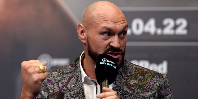 Tyson Fury gestures during a press conference at Wembley Stadium, London, Tuesday, March 1, 2022. 