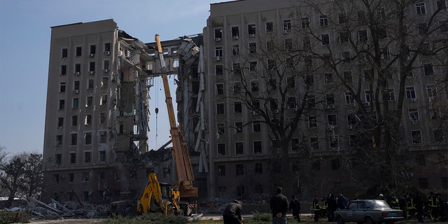 A crane operates at the regional government headquarters of Mykolaiv, Ukraine, after a Russian attack, on Wednesday, March 30, 2022.