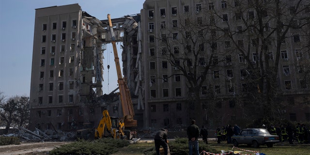 A crane operates at the regional government headquarters of Mykolaiv, Ukraine, after a Russian attack, on Wednesday, March 30, 2022.