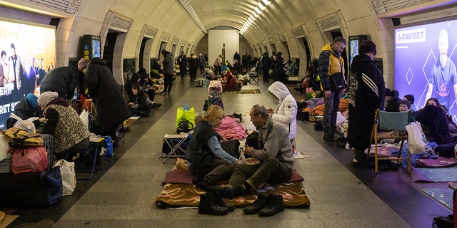 Residents take shelter in the lower level of a Kyiv metro station during Russian artillery strikes in Kyiv, Ukraine, on Wednesday, March 2, 2022.