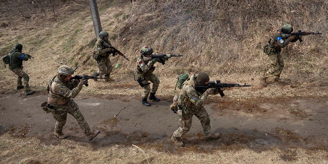 Soldados ucranianos de la 103.ª Brigada Separada de la Defensa Territorial de las Fuerzas Armadas disparan sus armas durante un ejercicio de entrenamiento en un lugar no revelado, cerca de Lviv, en el oeste de Ucrania, el martes 29 de marzo de 2022. 
