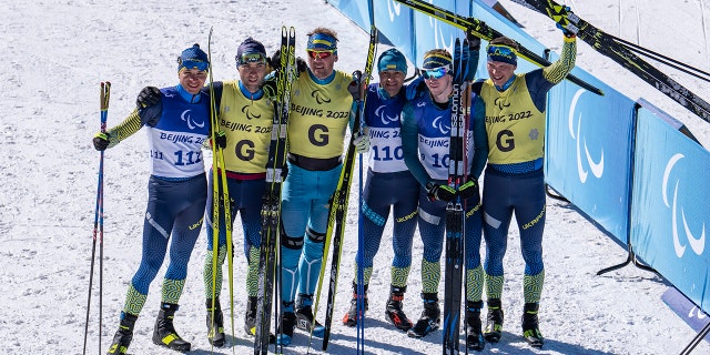 Left to right, Silver medalist Oleksandr Kazik of the Ukraine, alongside his guide Serhii Kucheriavyi, gold medalist Vitalii Lukianenko of the Ukraine, alongside his guide Boys Babar (left of center), and bronze medalist Dmytro Suiarko of the Ukraine, alongside his guide Oleksandr Nikonovych, pose together for a group photo after their domination in the Men's Sprint Vision Impaired Para Biathlon at the Zhangjiakou National Biathlon Centre. Beijing 2022 Winter Paralympic Games, Zhangjiakou, porcelana, sábado, marzo 5, 2022.