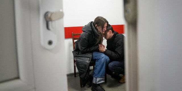 Marina Yatsko and her boyfriend Fedor comfort each other after her 18-month-old son Kirill was killed by shelling in a hospital in Mariupol, Ukraine, Friday, March 4, 2022.