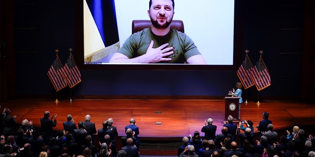 House Speaker Nancy Pelosi, D-Calif., right, introduces Ukrainian President Volodymyr Zelenskyy to speak via video to the U.S. Congress at the Capitol in Washington, March 16, 2022. 