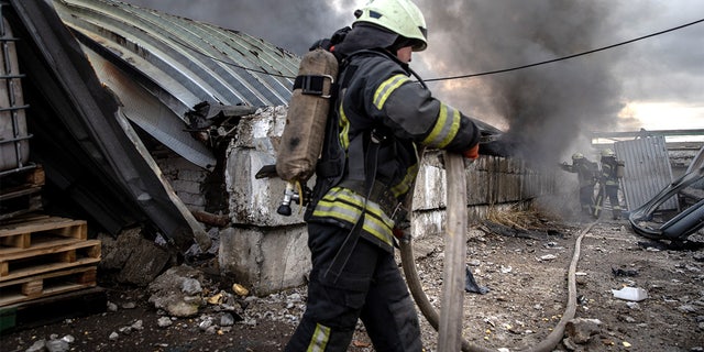 Firefighters try to extinguish a fire after a chemical warehouse was hit by Russian shelling on the eastern frontline near Kalynivka village on March 8, 2022, in Kyiv, Ukraine.