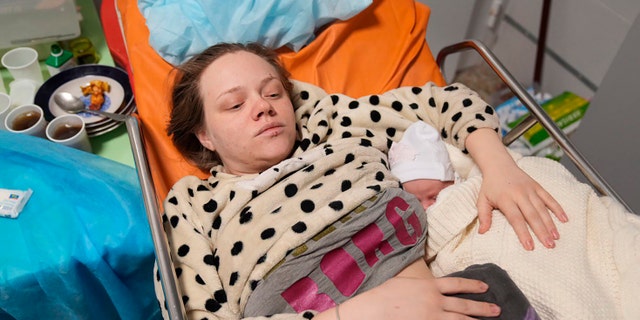 Mariana Vishegirskaya lies in a hospital bed after giving birth to her daughter Veronika, in Mariupol, Ukraine, Friday, March 11, 2022.