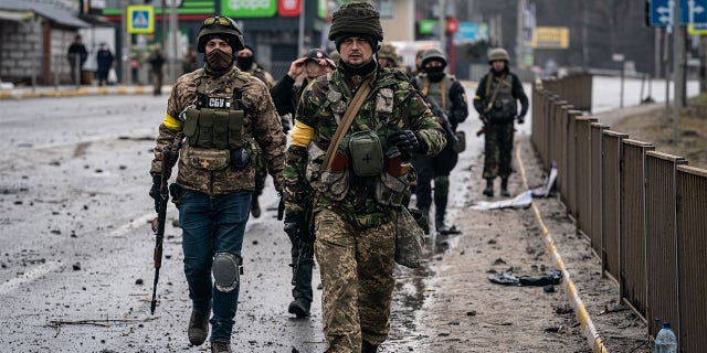 Ukrainian soldiers are seen near the recently collapsed bridge which was the target of a Russian missile, near the town of Irpin, Ukraine on March 3, 2022.