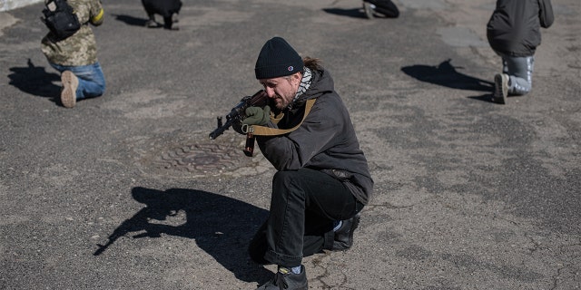 Civilians practice moving in groups at a military training exercise conducted by the Prosvita Society in Ivano-Frankivsk, Ukraine, March 11, 2022. 