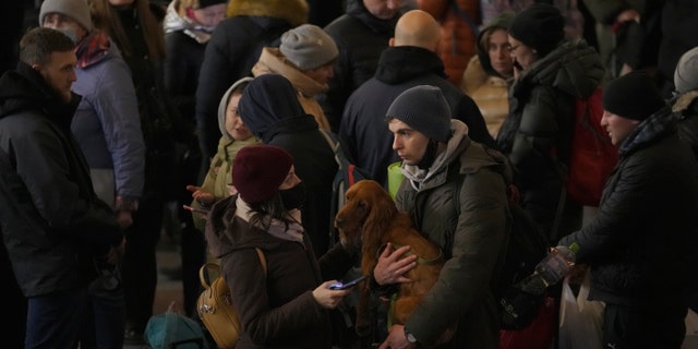 During this season of Lent, so many people are praying for the people of Ukraine. Shown here, a couple talks after people rushed to board a Lviv-bound train in Kyiv, Ukraine, Monday, on Feb. 28, 2022.