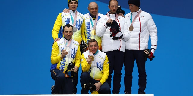 Ukrainian Paralympians rack up medals after escaping chaotic situation at home 4 Silver medalist Oleksandr Kazik from Ukraine and his guide Sergiy Kucheryaviy, gold medalist Vitaliy Luk'yanenko from Ukraine and his guide Ivan Marchyshak, and bronze medalist Anthony Chalencon from France and his guide Simon Valverde celebrate during of the Medal Ceremony of the Men's Visually Impaired 15km Biathlon on day eight of the PyeongChang 2018 Paralympic Games on March 17, 2018, in Pyeongchang-gun, South Korea.