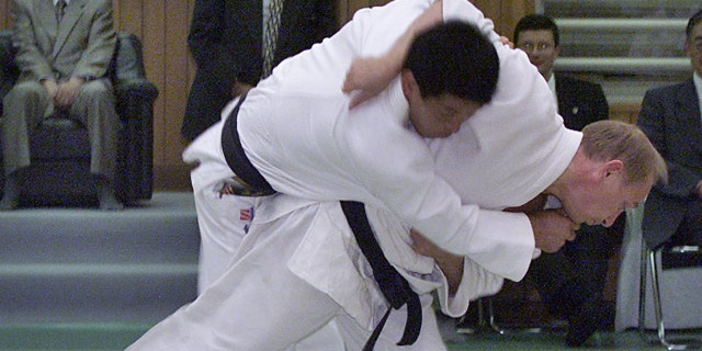 Russian President Vladimir Putin throws a Japanese judo expert during a judo exercise at Kodokan Sept. 5, 2000 in Tokyo.