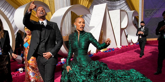 Will Smith, left, and Jada Pinkett Smith arrive at the Oscars on Sunday, March 27, 2022, at the Dolby Theatre in Los Angeles. 