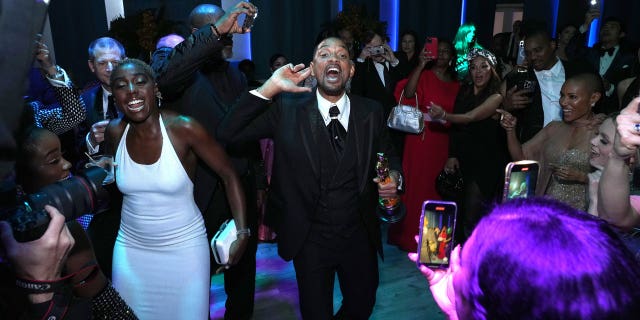Smith kept his Oscar in hand as he danced with party guests before making an early departure.