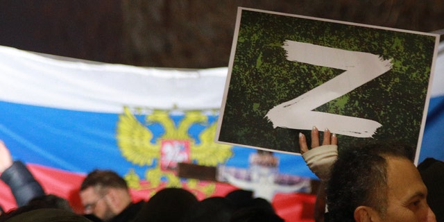 A protester holds a "Z" sign banner, in reference to Russian tanks marked with the letter, during a rally organized by Serbian right-wing organizations in support of Russian attacks on Ukraine, in Belgrade, Serbia, March 4, 2022. Around a thousand Serbian ultra-nationalist supporters marched in Belgrade in support of the Russian attacks on Ukraine.