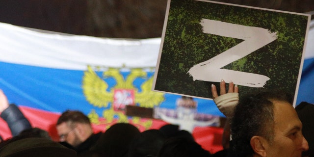 A protester holds a "Z" sign banner, in reference to Russian tanks marked with the letter, during a rally organized by Serbian right-wing organizations in support of Russian attacks on Ukraine, in Belgrade, Serbia, March 4, 2022. Around a thousand Serbian ultra-nationalist supporters marched in Belgrade in support of the Russian attacks on Ukraine.