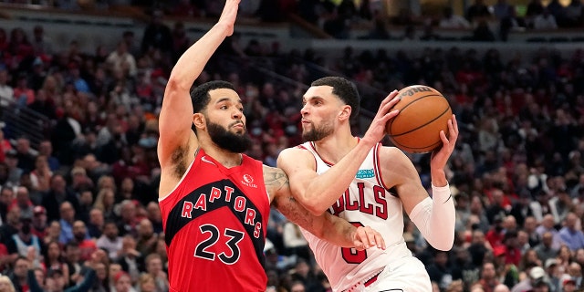Chicago Bulls' Zach LaVine, right, drives two the basket as Toronto Raptors' Fred VanVleet defends during the second half of an NBA basketball game Monday, March 21, 2022, in Chicago. The Bulls won 113-99.