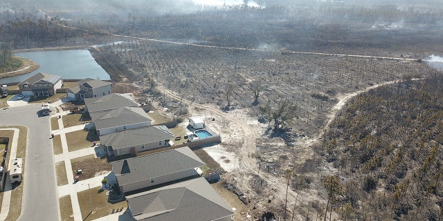 The 841-acre Adkins Avenue fire has destroyed at least two structures and damaged another 12 homes in Bay County since late Friday.