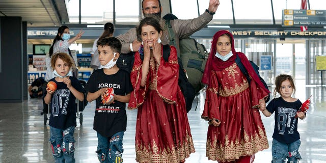 Families evacuated from Kabul, Afghanistan, arrive at Washington Dulles International Airport, in Chantilly, Virginia, on Aug. 27, 2021.