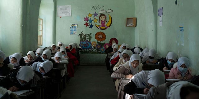 Afghan girls participate in a lesson inside a classroom at Tajrobawai Girls High School, in Herat, Afghanistan, Nov. 25, 2021.