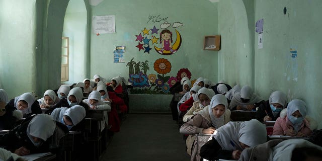 Afghan girls participate in a lesson inside a classroom at Tajrobawai Girls High School, in Herat, Afghanistan, Nov. 25, 2021.