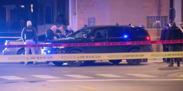 A Chicago police officer suffered a gunshot wound to a hand while another suffered a leg injury when a shootout ensued during a traffic stop late Monday, authorities said.