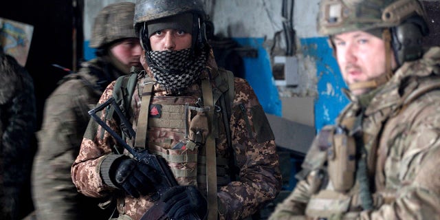 Servicemen of the Ukrainian Military Forces wait out the shelling in a shelter on a position in the Luhansk region on March 5, 2022. 