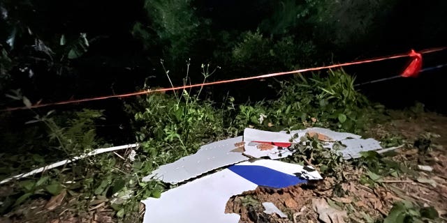 In this photo released by China's Xinhua News Agency, debris is seen at the site of a plane crash in Tengxian County in southern China's Guangxi Zhuang Autonomous Region, Tuesday, March 22, 2022. A China Eastern Boeing 737-800 with more than 100 people on board crashed in a remote mountainous area of southern China on Monday, officials said, setting off a forest fire visible from space in the country's worst air disaster in nearly a decade.