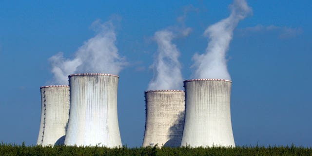 Four of the cooling towers of the Dukovany nuclear power plant rise high above the natural surroundings of Dukovany, Czech Republic. Austria is taking the European Union to court over a move that would classify natural gas and nuclear power and sustainable energies. 