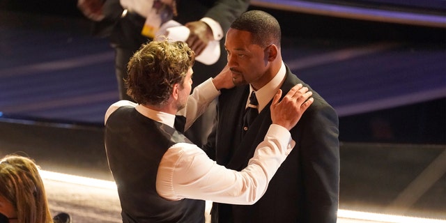 Bradley Cooper, left, and Will Smith appear in the audience at the Oscars on Sunday, March 27, 2022, at the Dolby Theatre in Los Angeles. (AP Photo/Chris Pizzello)