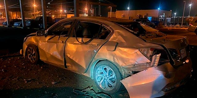 In this photo provided by the Saudi Press Agency, a damaged car is parked at an Aramco terminal in the southern border town of Jizan, Saudi Arabia, Sunday, March 20, 2022. 