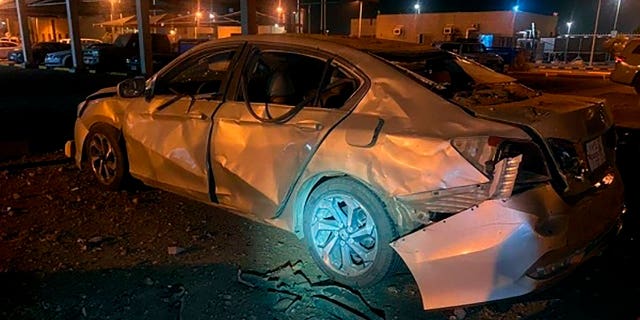 A damaged car is parked at an Aramco terminal in the southern border town of Jizan, Saudi Arabia, March 20, 2022. Yemen's Houthi rebels unleashed a barrage of drone and missile strikes on Saudi Arabia that targeted a liquefied natural gas plant, water desalination plant, oil facility and power station, Saudi state-run media reported.
