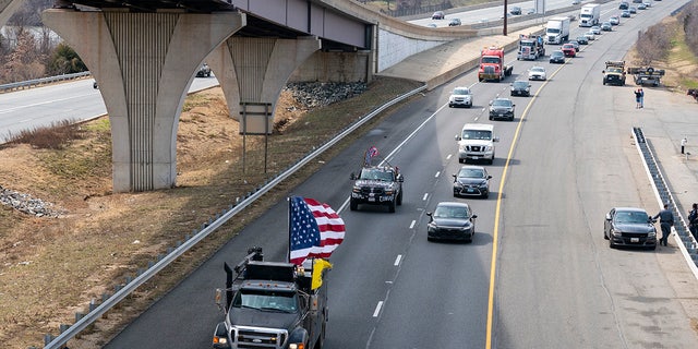 A convoy of trucks and other vehicles travels the I-495 Capital Beltway near the Woodrow Wilson Bridge, to protest mandates and other issues, Sunday, March, 6, 2022, in Fort Washington, Md. (AP Photo/Alex Brandon)