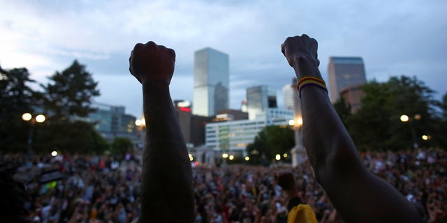 Demonstrators raise their fists at a protest against racial inequality in the aftermath of the death in Minneapolis police custody of George Floyd, in Civic Center Park, Denver, Colorado, U.S., June 3, 2020.  