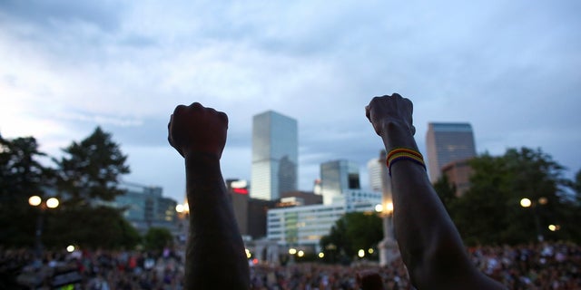 Demonstrators raise their fists at a protest against racial inequality in the aftermath of the death in Minneapolis police custody of George Floyd, in Civic Center Park, Denver, Colorado, U.S., June 3, 2020.