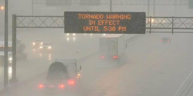 The Mississippi Department of Transportation digital message board warns drivers along I-55 southbound in Jackson of a tornado warning during a rainstorm during the outbreak of severe weather in the state, Wednesday, March 30, 2022. 