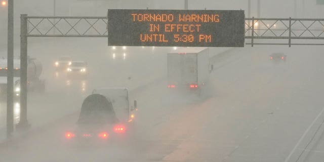 The Mississippi Department of Transportation digital message board warns drivers along I-55 southbound in Jackson of a tornado warning during a rainstorm during the outbreak of severe weather in the state, Wednesday, March 30, 2022.